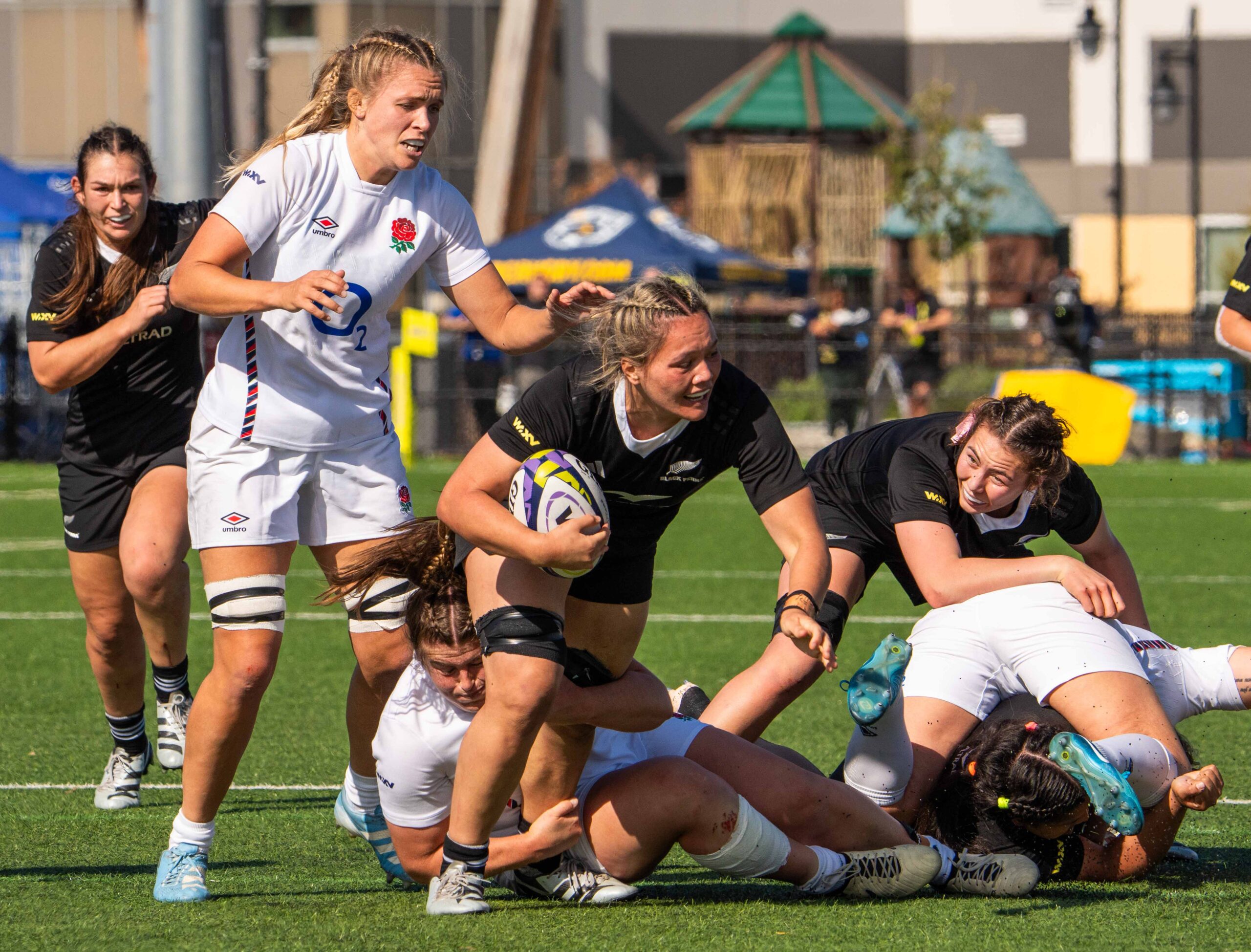 New Zealand Black Ferns player in black kit running with the ball during a WXV tournament game.