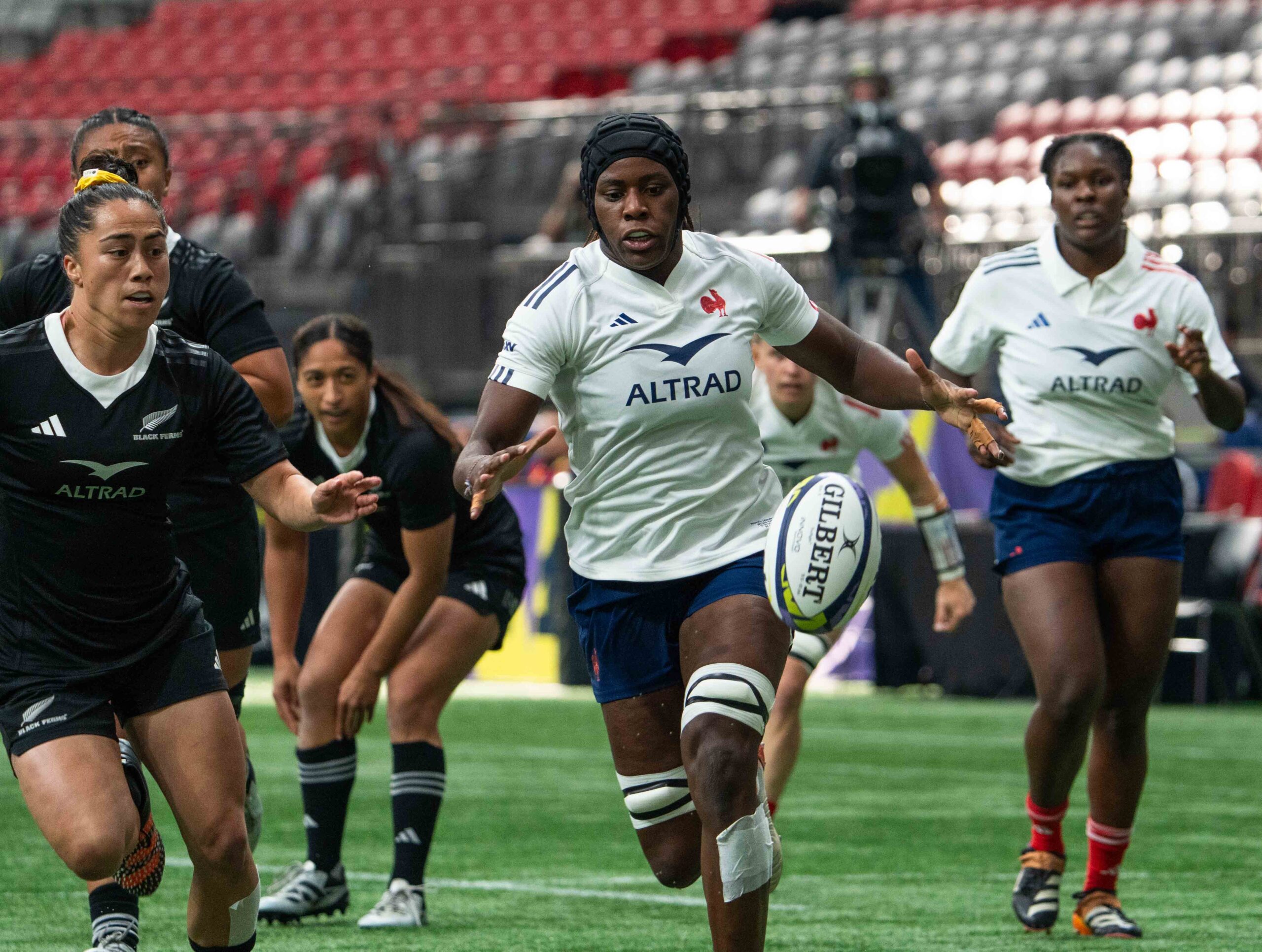 France Women's Rugby player wearing a protective scrum cap running with the ball during a WXV tournament match