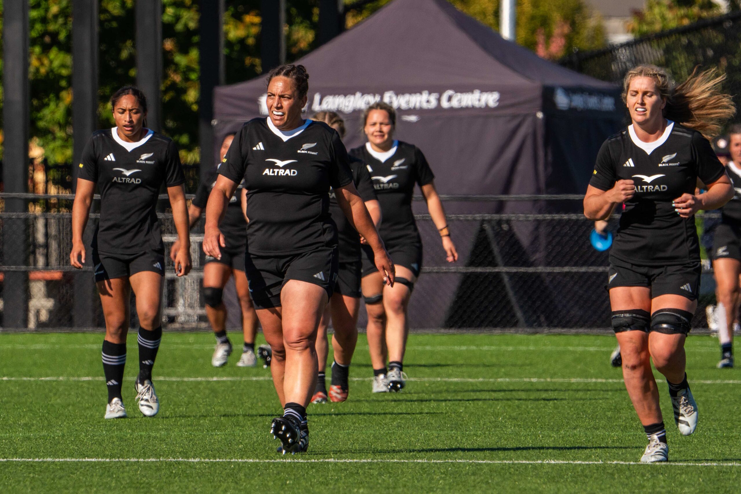 New Zealand Black Ferns players walking on the pitch during a rugby match at Langley Events Centre.