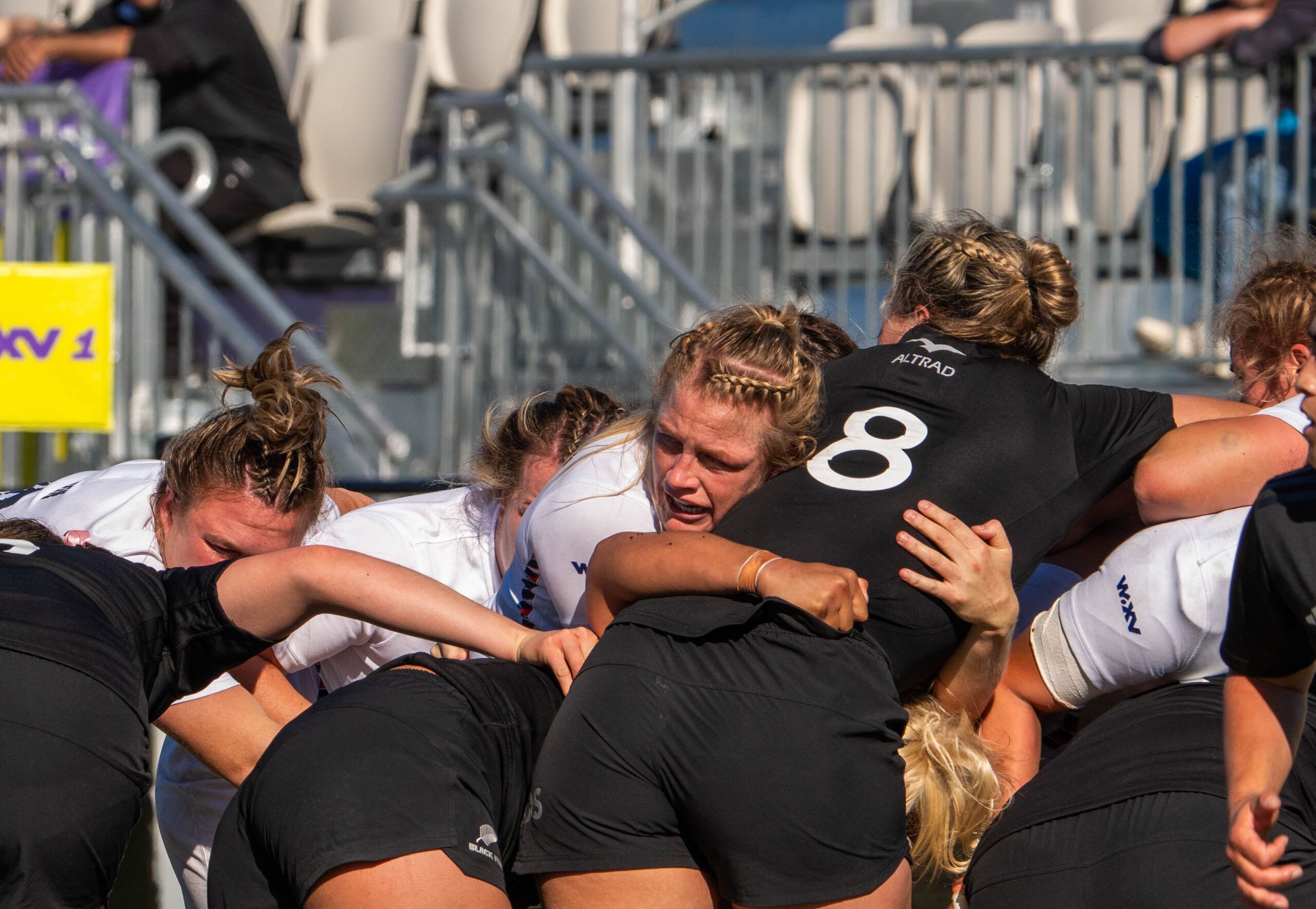 Close up of a rugby scrum with England and New Zealand players bound together in a test match.