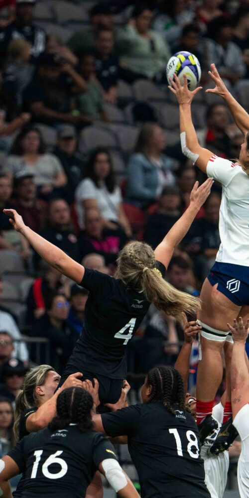 Rugby lineout action with a France player being lifted to catch the ball against New Zealand.