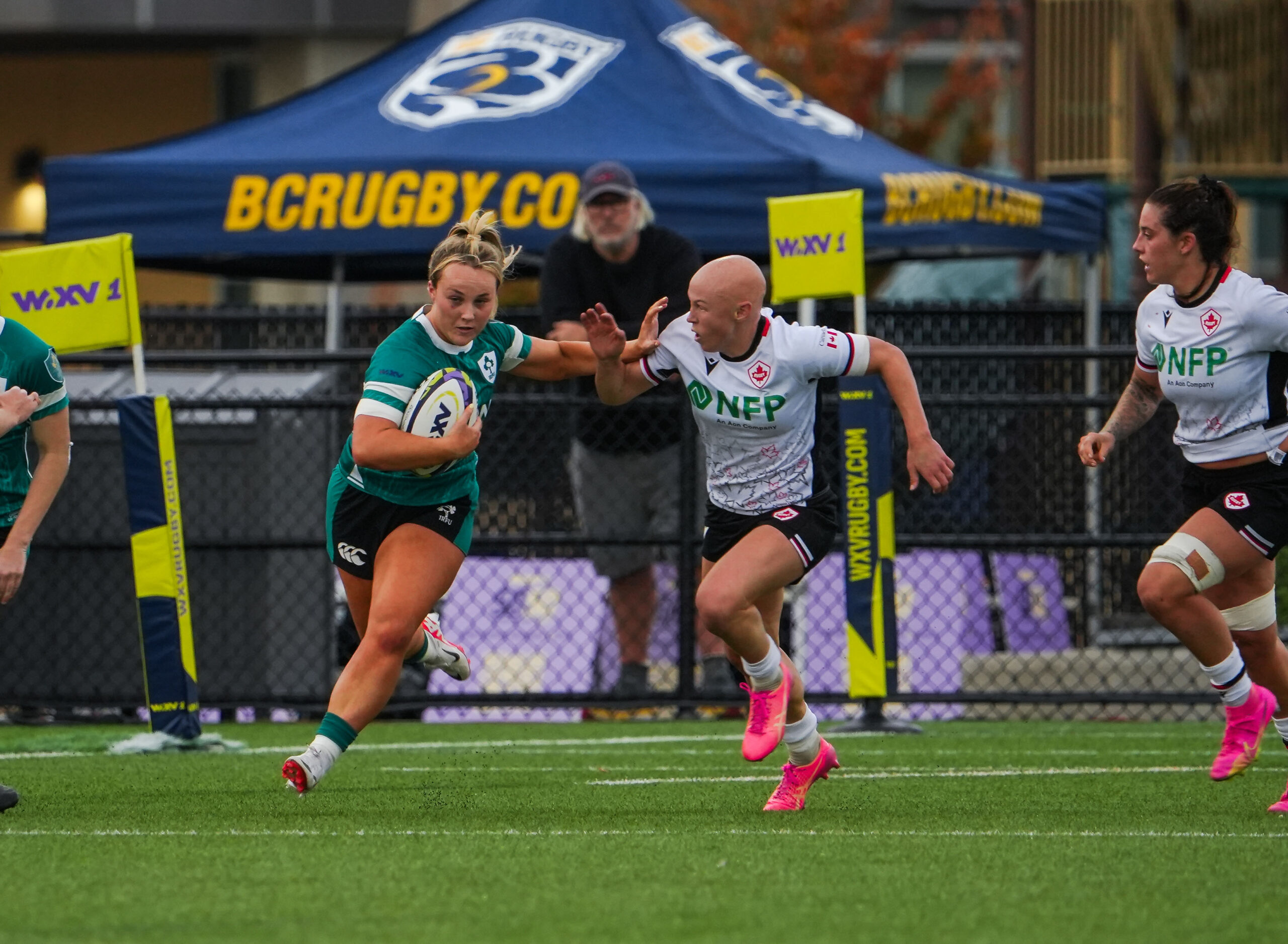 Portrait of an Ireland Women's Rugby player wearing a protective scrum cap on the field.