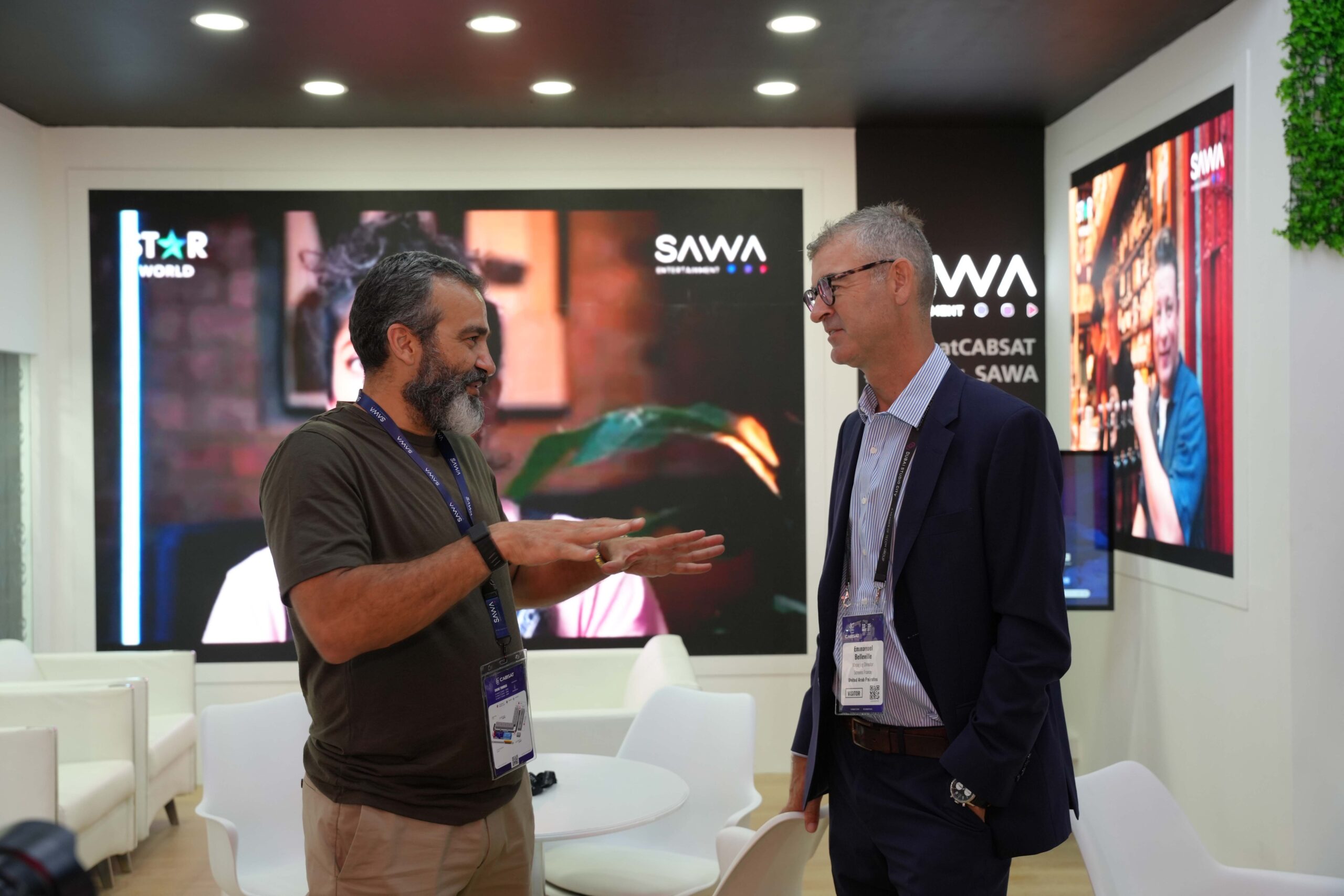 Media experts discussing digital trends at the SAWA booth, CABSAT exhibition.