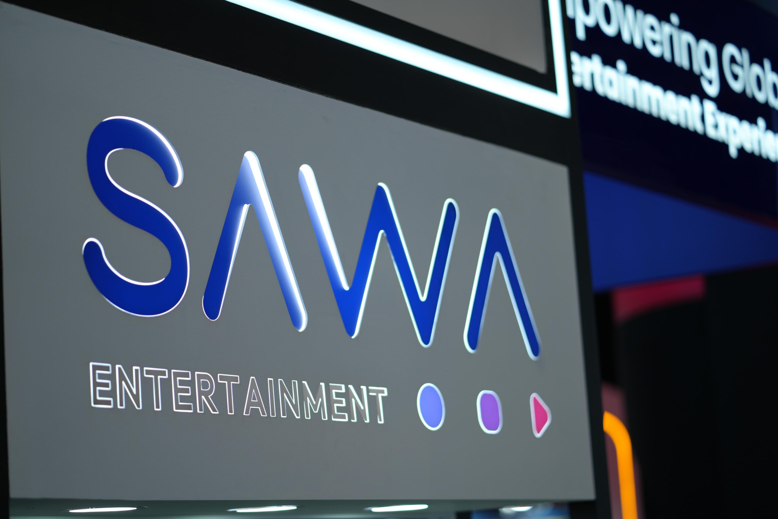 Close-up of SAWA Entertainment logo at a professional media exhibition.