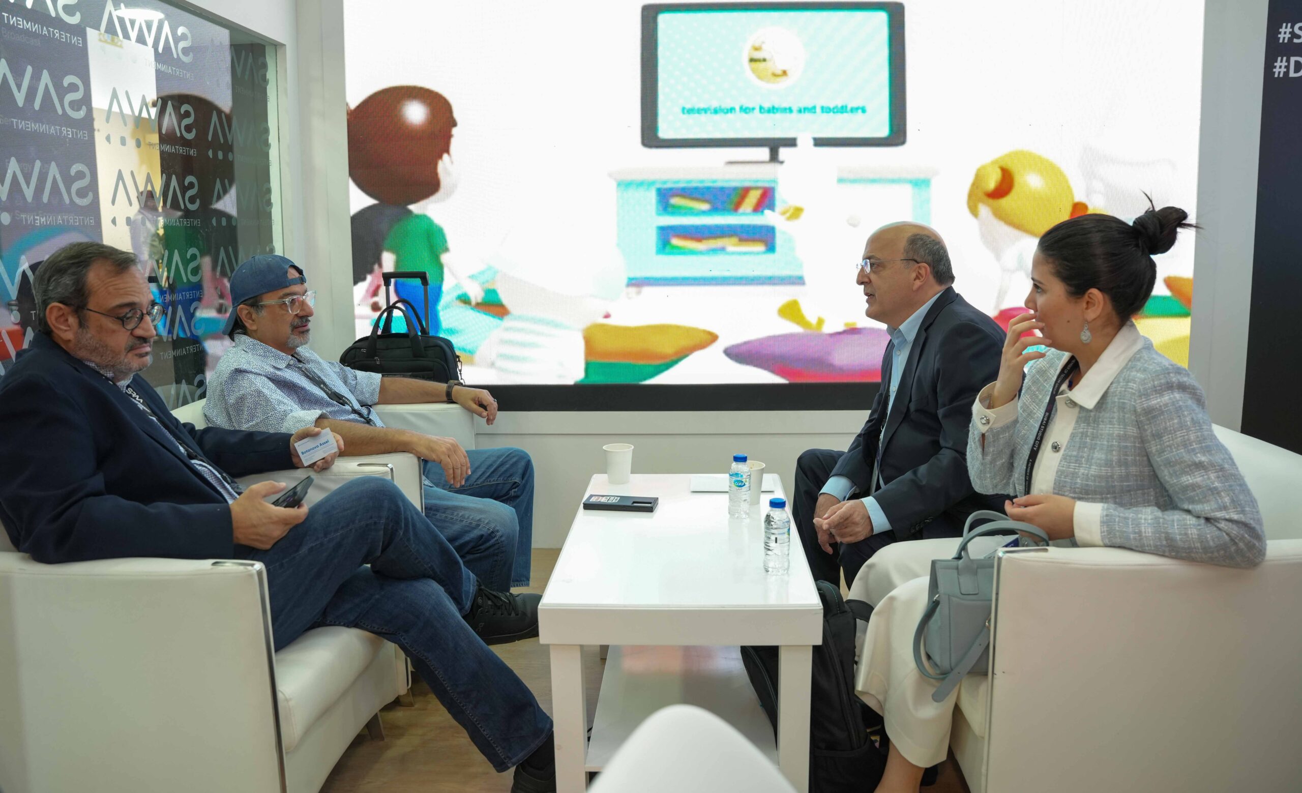 Industry professionals networking at the SAWA Entertainment booth during CABSAT.