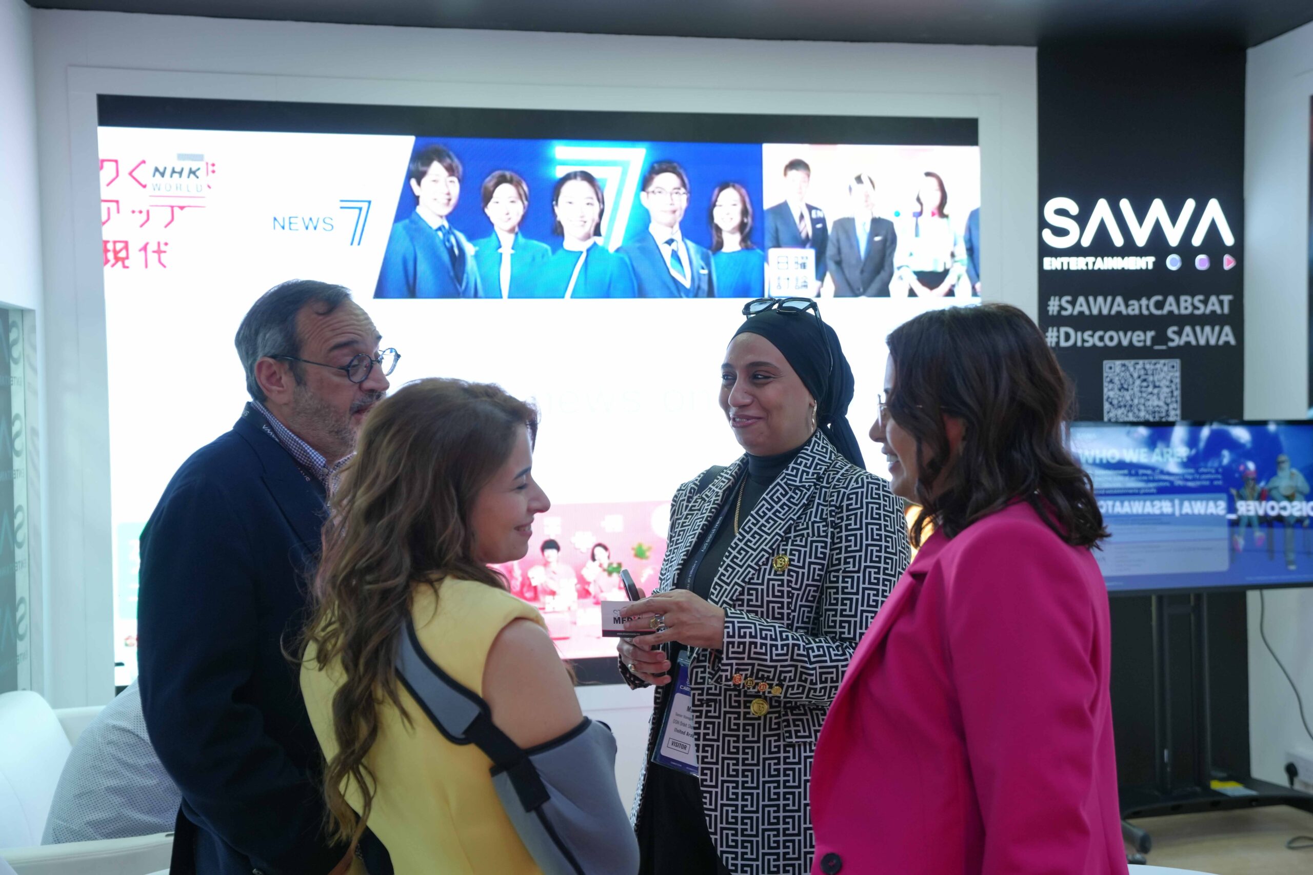 Media industry professionals discussing NHK World and SAWA Entertainment partnerships.