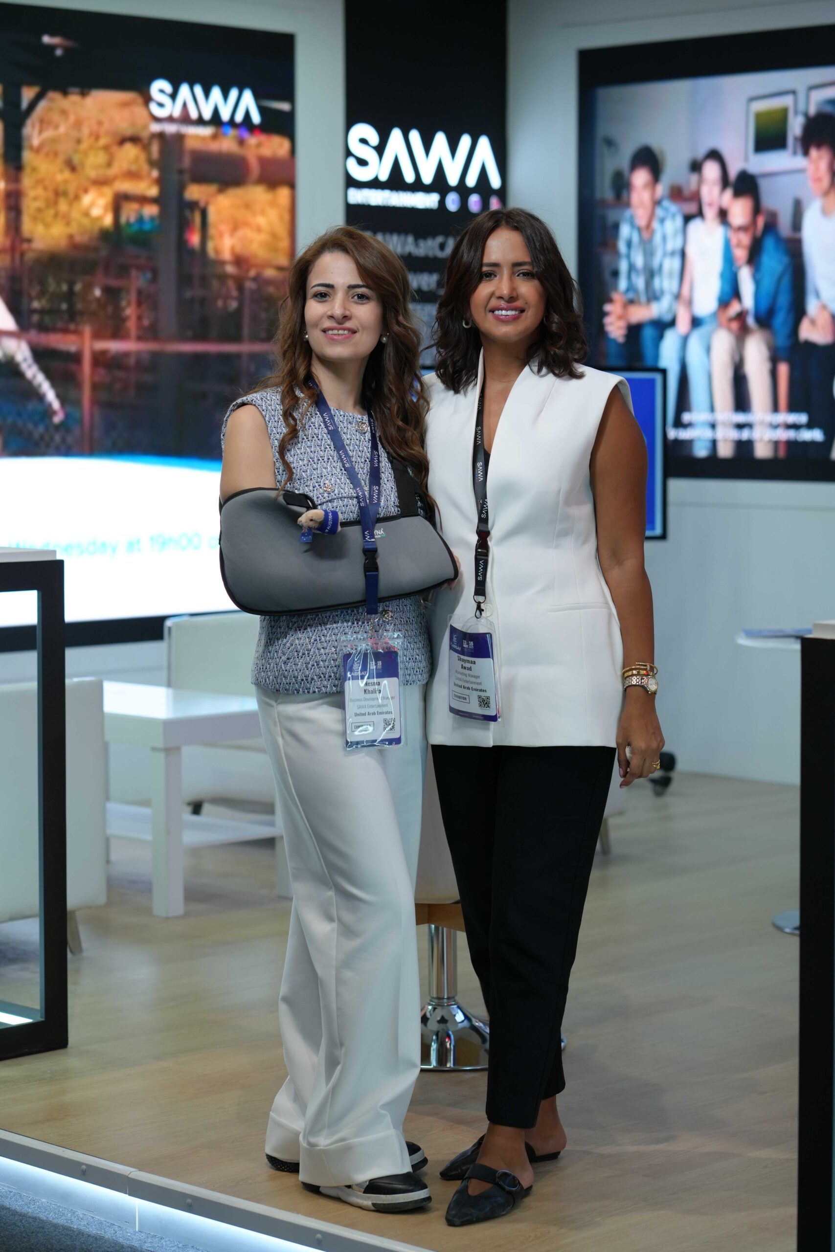 Full-length photo of Shaymaa Awad and colleague at CABSAT Dubai trade show