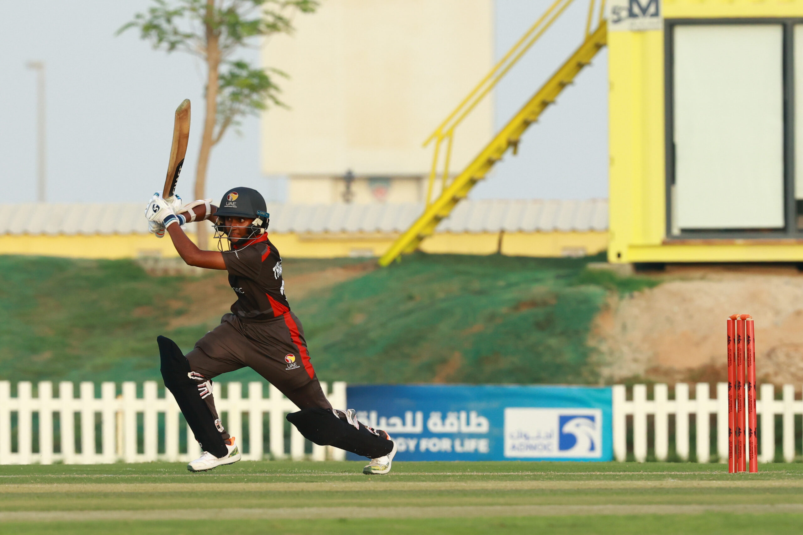 UAE women's cricket team batter playing a shot during an international match at the Abu Dhabi Cricket and Sports Hub