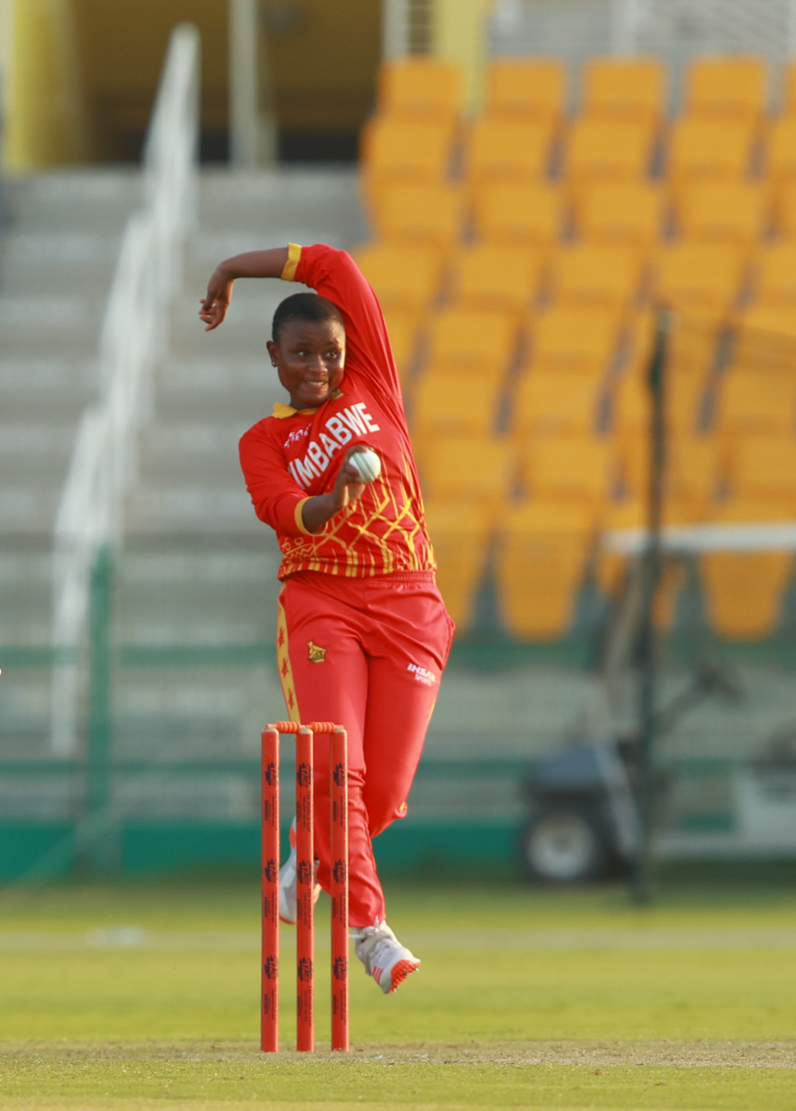 Zimbabwe women’s national cricket team bowler in mid-delivery action during a match in the UAE.