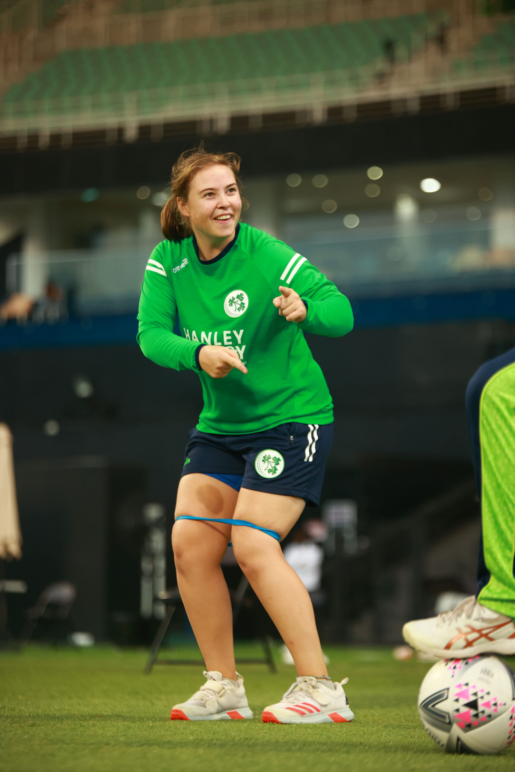 ireland cricketer smiling while performing lateral band walks for glute activation.